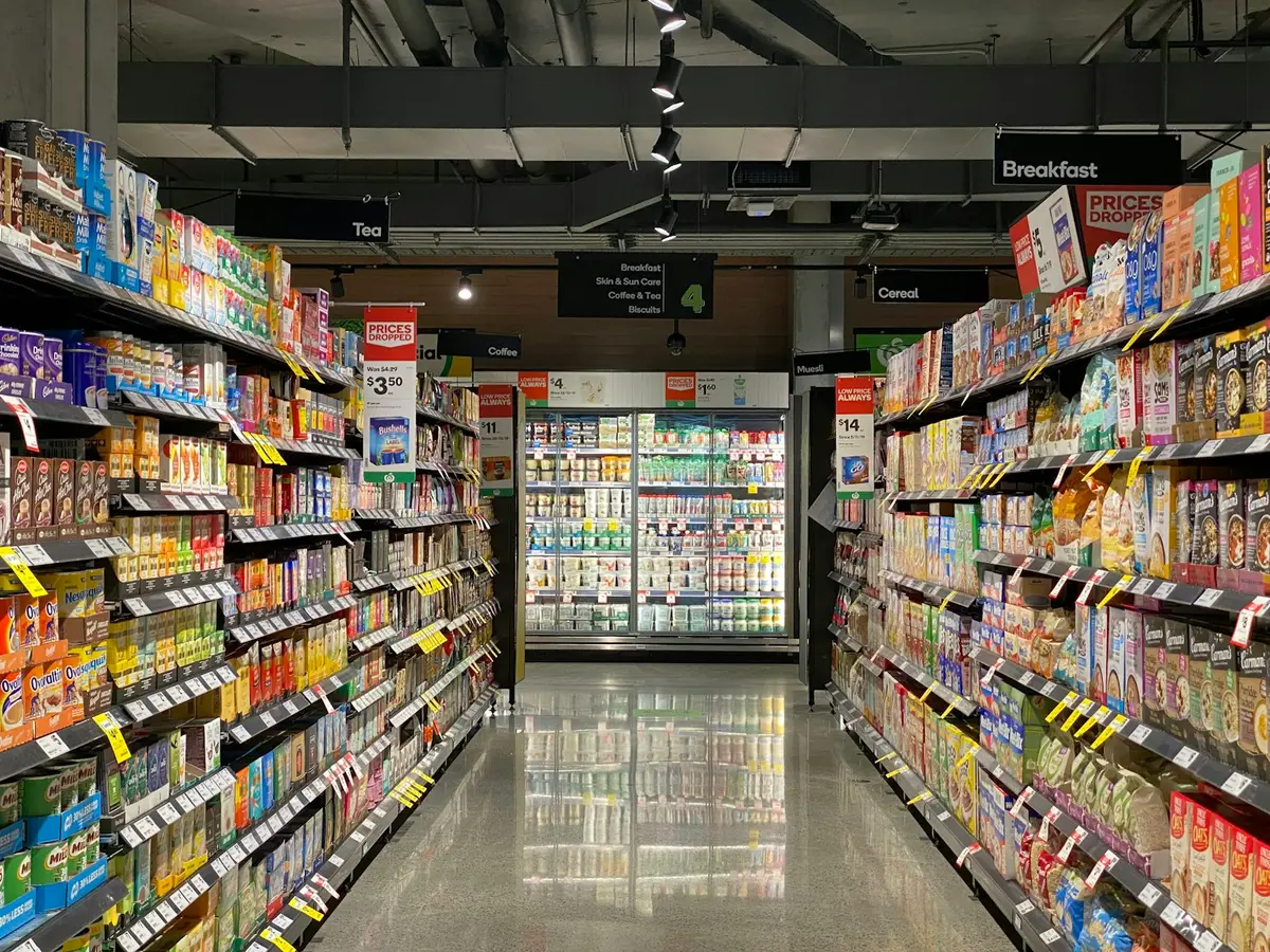 Supermarket aisle with stocked shelves, the setting for a retail audit